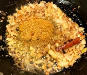 frying ground spices on onions