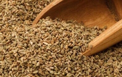 carom seeds in a large sppon. post on what is carom seed and their use for health benefits