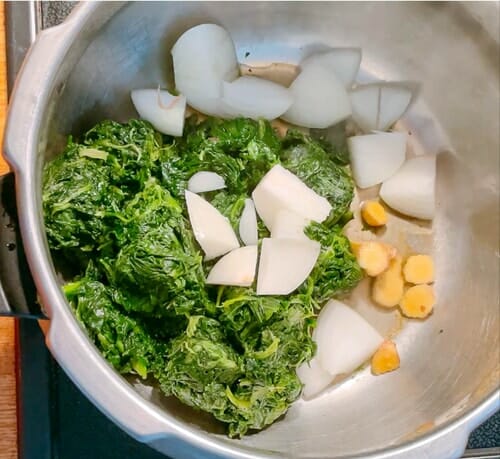 Spinach onions ginger in a pot for palak paneer